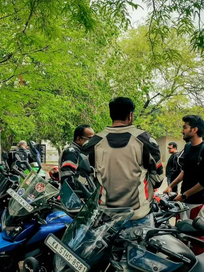 Members gathered around the bikes, sharing stories and passion. This is the heart of our community.