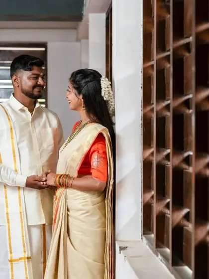 An intimate moment from a traditional pre-wedding shoot, with the couple sharing a look by a window.