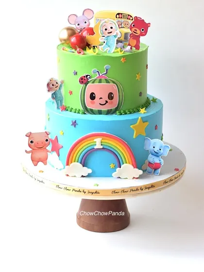 For the little ones who love Cocomelon, I designed this cheerful two-tier cake. The bottom tier features a rainbow and characters, while the top tier brings the whole Cocomelon family together, all made with smooth, delicious buttercream.