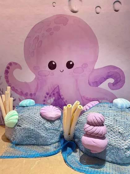 The details of our mermaid party included custom-designed treat boxes with seahorses and shells, and adorable octopus characters that added to the underwater fantasy.