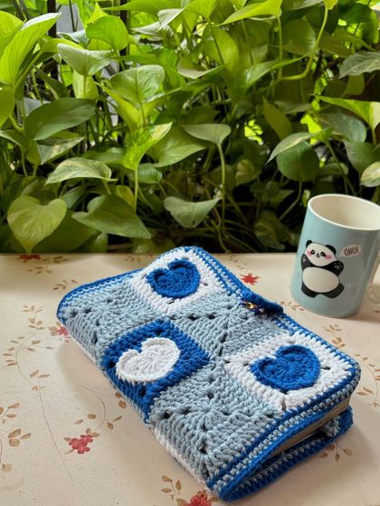 The blue heart book cover styled with a cute panda mug, ready for a cozy reading session.