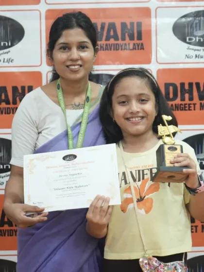 A teacher and student share a happy moment during the prize distribution ceremony.