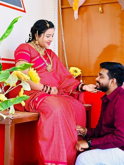 A beautiful moment from a traditional maternity shoot in our 'Halli Mane' setup. The husband-to-be lovingly offers his wife a bite to eat, a gesture of care and affection.