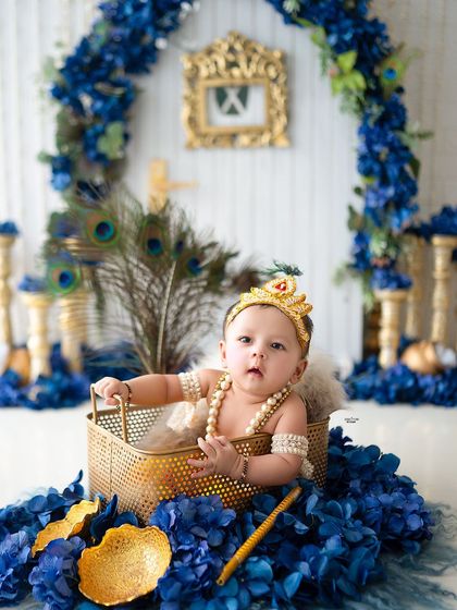 A curious little Krishna peeking out from a golden basket.