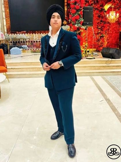 Our client looks absolutely dapper in a custom-crafted teal three-piece suit. The unique color and perfect tailoring make him stand out at his event.