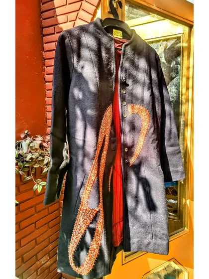 This is a perfect example of upcycling with a touch of history. I used a 400-year-old antique Jamevar patch and placed it on a classic navy woollen coat. The result is a completely unique, statement winter piece with a story to tell.