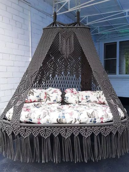 A client review photo of our beautiful dark grey sofa swing. The floral printed mattress adds a touch of personality and charm.