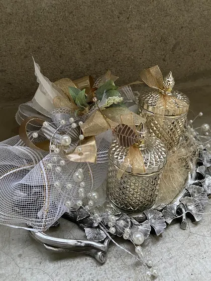 For milestone birthdays and memorable anniversaries, we curate custom hampers like this one. Set on a silver-leafed tray, it features our crystal candle jars and is wrapped to perfection.