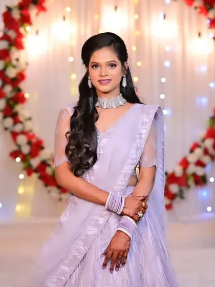A full-length portrait of the bride in her engagement lehenga, looking graceful and elegant.
