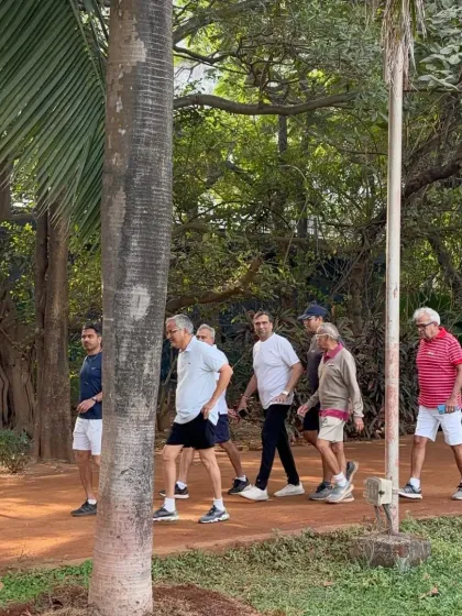 A group of men enjoying a brisk morning walk together on one of our dirt tracks. This shows the social aspect of our park, where friends gather to stay active and catch up.