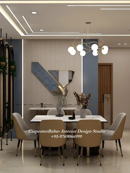 This dining area uses a dark blue accent wall and gold decorative wreaths to create a moody and luxurious atmosphere. The vertical partition adds a modern touch.