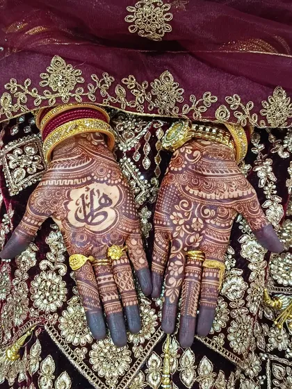 This is what my bridal henna stain looks like, complete with traditional attire. The design includes personalized Arabic calligraphy, showing the versatility of the cones.