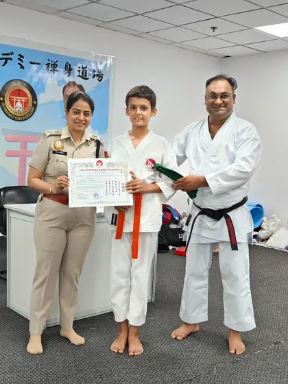 A student advances to his next level, receiving his new belt and certificate. These ceremonies are important milestones in a student's karate journey, marking their dedication and skill progression.