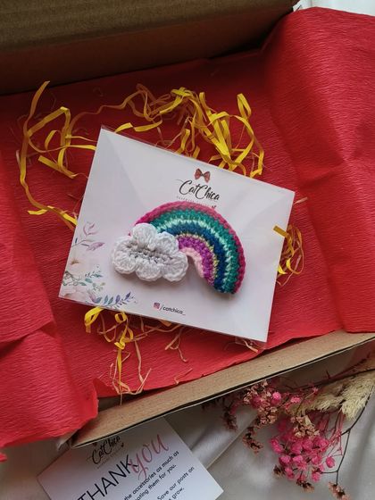 This rainbow clip is packaged and ready to be sent as a gift. The red tissue paper makes it feel extra special.