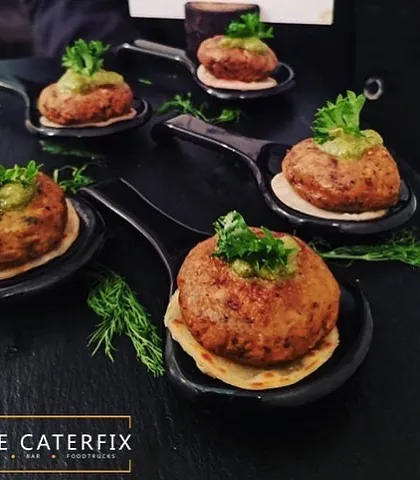 This is another view of my Galouti kebabs, showcasing the careful presentation on individual serving spoons. I ensure every detail is perfect, from the taste of the food to the way it is served.