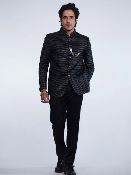 A full-length shot of the black striped bandhgala set, a powerful and sophisticated look for any formal occasion.