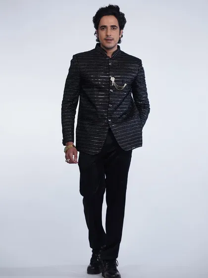 A full-length shot of the black striped bandhgala set, a powerful and sophisticated look for any formal occasion.