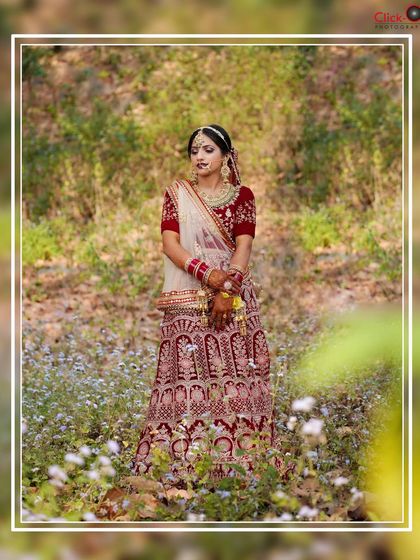 A full-length bridal portrait in a field of flowers, creating a beautiful, natural setting for the bride in her traditional attire.