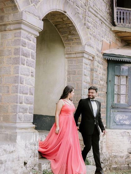 Emerging from a rustic stone archway, this couple shares a look of love, blending the elegance of their formal wear with the just rugged charm of the location.