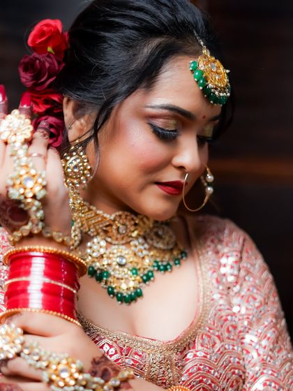 A beautiful shot focusing on the intricate hand jewelry (hathphool) and the overall bridal elegance.
