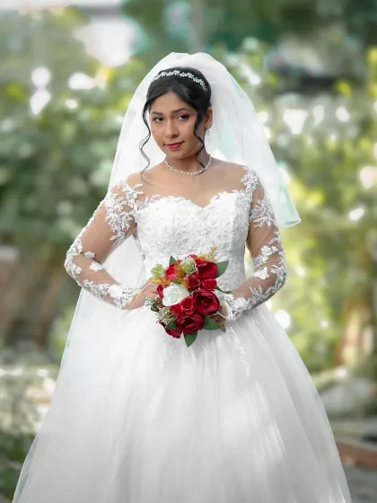 A lovely three-quarter length bridal portrait in a garden setting. The soft, out-of-focus background makes the bride stand out beautifully.