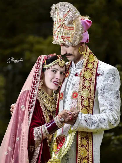 This portrait captures the beautiful bond between the couple, dressed in traditional Himachali wedding attire. The groom's embrace feels both protective and loving.