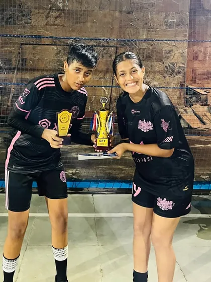 Two champions holding their trophies high after the Decathlon 4v4 win.