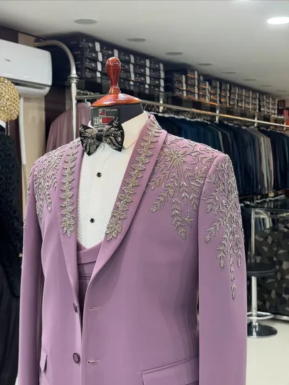 A close-up shot of the lavender tuxedo in my studio. You can see the quality of the fabric and the precision of the silver handwork that makes this piece so special.
