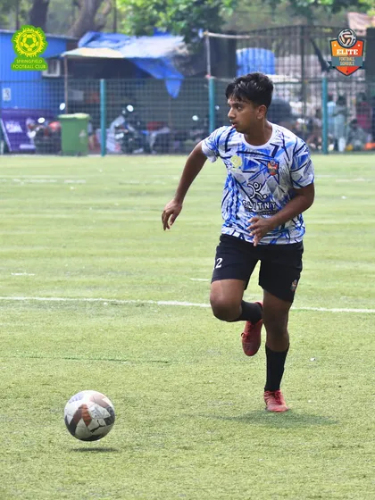 An action shot of our player driving the ball forward. Our training emphasizes proactive and attacking football.
