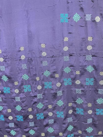 The gradation of blue tones in the embroidery gives this contemporary Kasuti saree depth and movement.