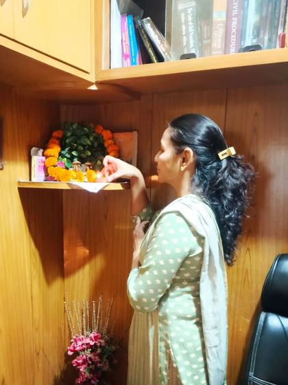 A colleague performing rituals at the office shrine.