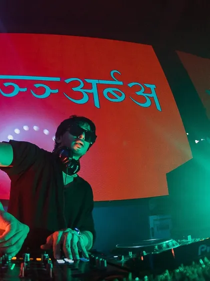 A close-up of me at the decks in Nagpur, with my name in Hindi on the screen behind me. This shows my connection to my cultural roots.