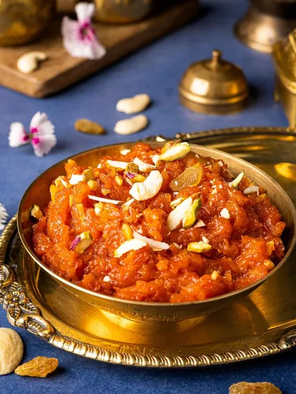 Another perspective of the Gajar Halwa, focusing on the rich texture and generous garnish of nuts and raisins. This is pure winter comfort in a bowl.