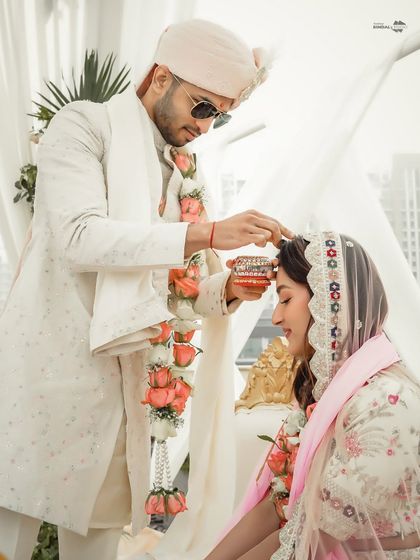 The sindoor ceremony is a pivotal moment in a Hindu wedding. I capture this intimate ritual, where the groom applies sindoor to his bride's forehead, symbolizing their new marital status.