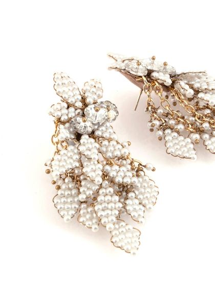 A close-up view reveals the craftsmanship of these modern pearl earrings.
