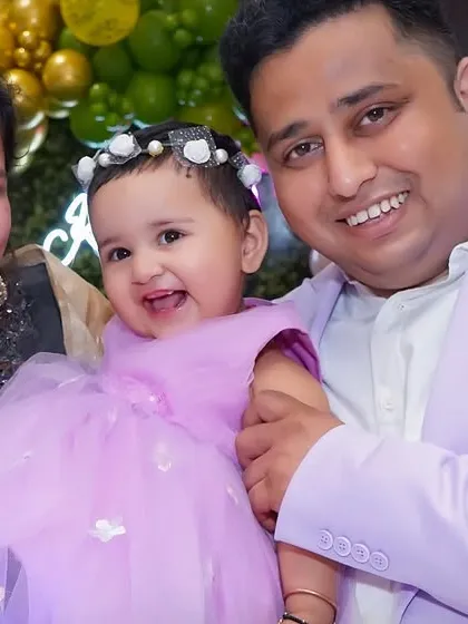 A happy family portrait featuring parents with their baby girl on her birthday. We believe in capturing the whole family during these important milestones.