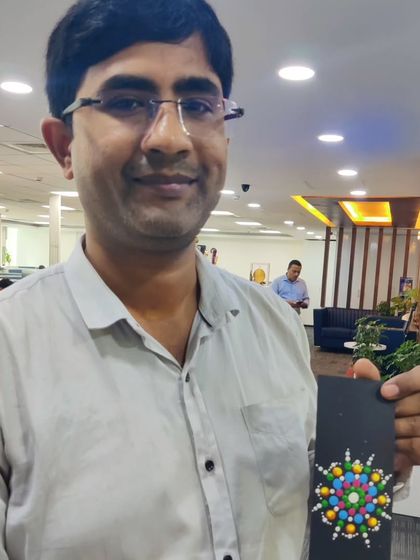 This employee proudly shows the intricate dot mandala he designed on a bookmark. These short, 20-minute art sessions are a proven way to introduce mindfulness and reduce stress during a busy workday.