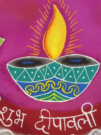 Close-up of the central diya and "Shubh Deepavali" greeting. The bright flame and intricate patterns on the lamp are designed to be the focal point of the festive artwork.