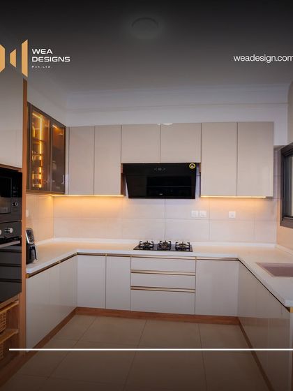 A sleek and modern acrylic kitchen from our Sobha Royal Pavilion project, featuring high-gloss neutral cabinets and integrated appliances.