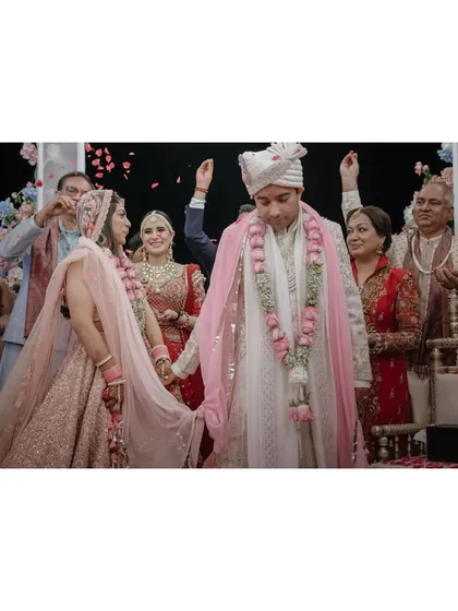 Sugam and Anchit during their pheras, surrounded by family showering them with petals. Sugam’s strength and composure, mixed with her deep emotions, tell a powerful story of this life-changing moment.