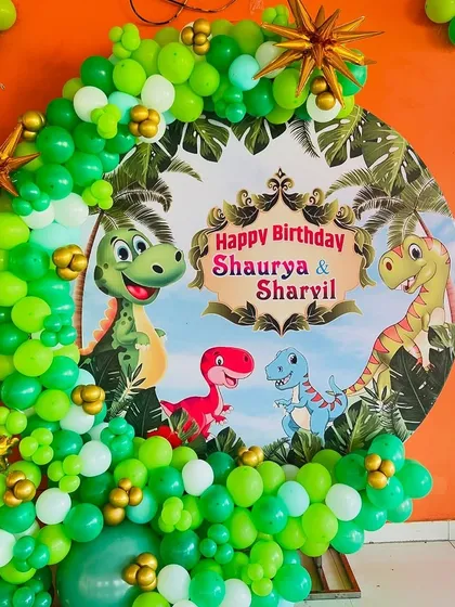 A closer look at our detailed jungle theme backdrop, featuring friendly dinosaurs and a personalized "Happy Birthday" message for the birthday boys.