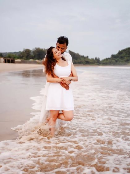A romantic embrace in the ocean waves during a pre-wedding shoot, capturing a moment of passion and intimacy.