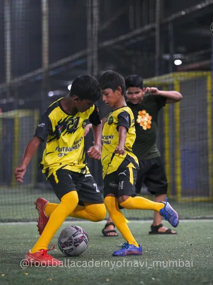 Two players locked in a duel for the ball, showcasing the competitive spirit we foster in our training matches.