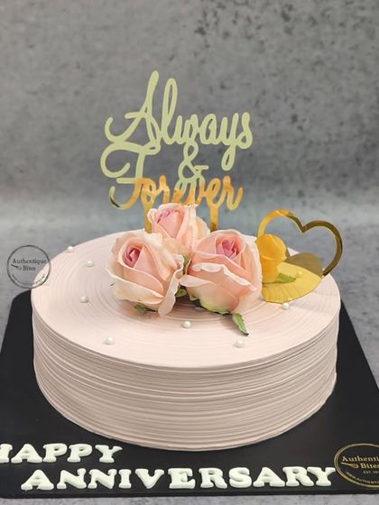 A simple yet elegant Tiramisu anniversary cake. This single-tier cake is decorated with three pink roses and an "Always & Forever" topper, proving that beauty lies in simplicity.