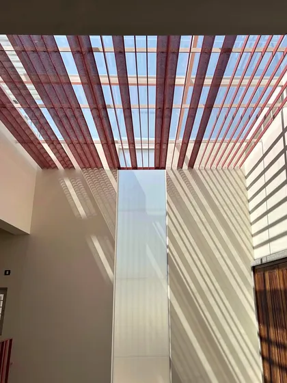 A look up at a skylight we are currently building. The semi-circular perforated bands are designed to cut the sun's glare, allowing just the right amount of soft light to filter down into the home.