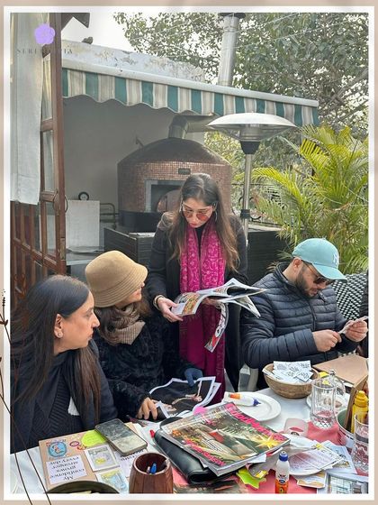 Guiding the group through the process. I often walk around to offer support, answer questions, and help participants find clarity as they build their manifestation boards.