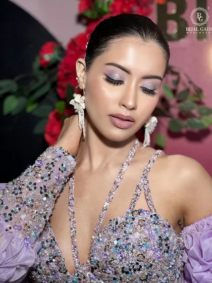 Eyes closed, this shot gives a perfect view of the soft lilac and silver eyeshadow. The makeup is blended to perfection, creating a dreamy and romantic feel.