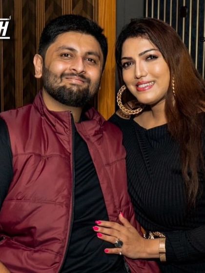 A happy couple enjoying the party atmosphere.