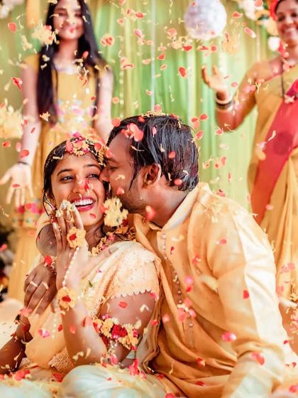 A romantic moment amidst a shower of flower petals during the Haldi ceremony. We capture both the fun and the romance of the day.