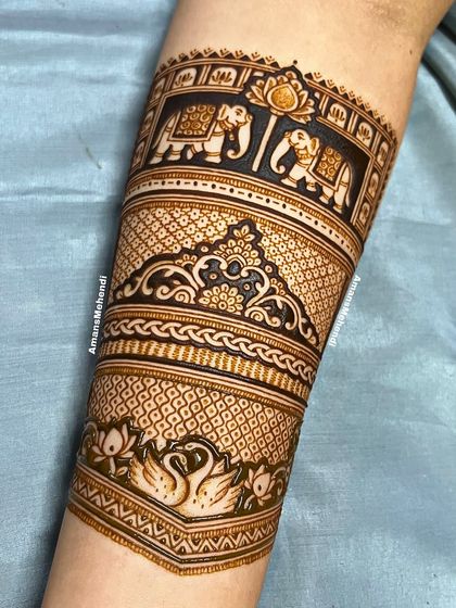 A slightly different angle of the regal arm band, showing the beautiful details of the elephants, swans, and the intricate filler patterns.